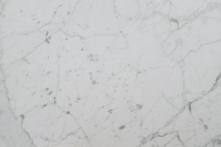 Close-up of natural marble veining, showing the irregular pattern manufactured surfaces repeat